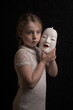 © Milou Dirks - Fine art classic studio portrait of young blonde girl holding white asian mask