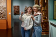 © JENOCHE - Woman and his daughter view the artworks