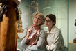 © JENOCHE - Attentive tween girl with senior woman exploring art museum