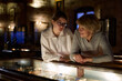 © JENOCHE - grandmother and granddaughter looking at medieval expositions in museum