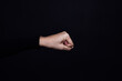 © Юля Бурмистрова - Caucasian person clenched fist isolated on black background. Copy space. Domestic violence. Physical and psychological abuse, relative aggression, gaslighting.