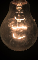 Sticker - A Filament bulb lighting at night. The photo taken taking the bulb on focus.