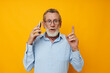 © Tatiana - Portrait of happy senior man talking on the phone emotions isolated background