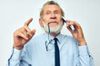 © Tatiana - Senior grey-haired man in a shirt with a tie Finance and Investments Bitcoin light background