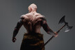 © Fxquadro - Tattooed viking with steel axe his back facing to camera