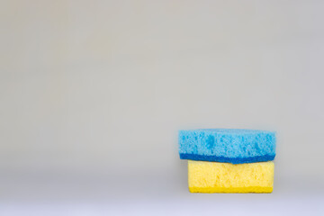 two sponges for cleaning. yellow, blue colors. space for text.
Kitchen cleaning set sponge background. sponge in woman's hand. space for text. 