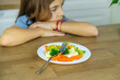 © yanadjan - The child eats vegetables on a chair. Selective focus.