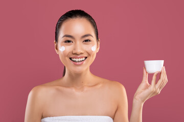 Wall Mural - Beautiful japanese lady holding white jar with cream