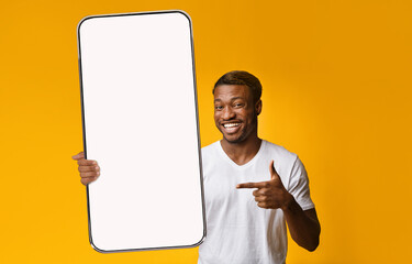 Canvas Print - Black guy showing white empty smartphone screen, closeup