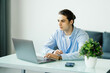 © F8  \ Suport Ukraine - Young businessman working at home with laptop and papers on desk