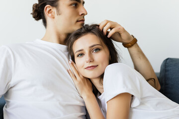  Close up of a charming young couple posing in their living room