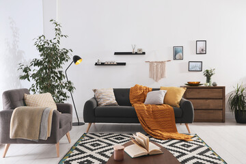 Poster - Stylish living room interior with comfortable sofa and armchair