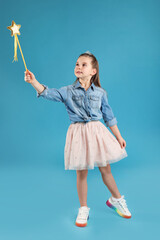 Poster - Cute girl in diadem with magic wand on light blue background. Little princess