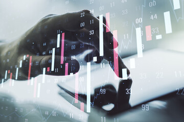 Multi exposure of abstract financial graph and hand working with a digital tablet on background, financial and trading concept