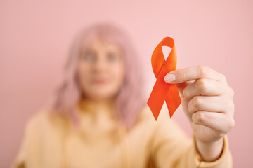 Woman hand holding red ribbon for december world aids day, Cancer Awareness month. Health care and world cancer day concept