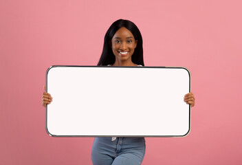 Cheerful black lady showing big white empty smartphone screen