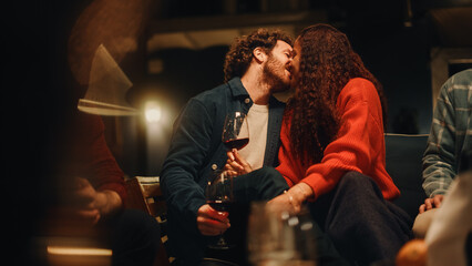 Loving Couple Sitting Together at a Garden Party Celebration with Friends on a Warm Summer Evening. Beautiful Man and Woman Enjoy Life on a Terrace, Talk, Relax on Weekend, Have Fun, Drink Wine.