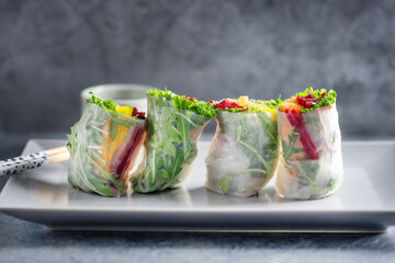 Canvas Print - Rice paper roll with vegetables on plate