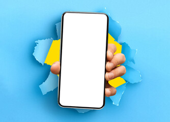 Person showing white empty smartphone screen breaking through paper