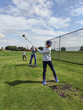 © spass - Happy family playing golf on green grass at golf club at summer