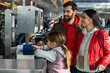 © NFstock - Mother, father and daughter preparing to the traveling while undergoing check-in procedures at the airport. Stock photo