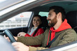 © NFstock - Happy caucasian couple fastened with seat belts looking at each other while sitting at the car during the journey. Safe traveling concept