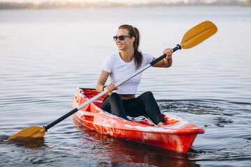 Young woman kayaking on the lake