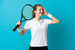 © luismolinero - Young woman tennis player isolated on blue background smiling a lot