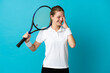 © luismolinero - Young woman tennis player isolated on blue background laughing
