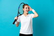© luismolinero - Young woman tennis player isolated on blue background doing surprise gesture while looking to the side