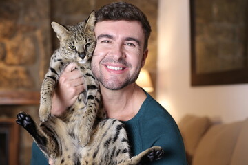 Wall Mural - Man and his expensive F1 Savannah cat