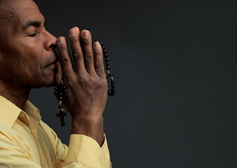 man praying to god with hands together stock photo