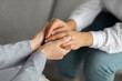 © Prostock-studio - Psychological support. Psychotherapist offering help to young woman, holding her hands during psychotherapy session