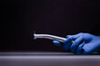 a dental tip and a metal bur in dentistry treats caries a blue gloved hand holds