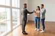 Real Estate Agent Giving Keys To Excited Buyers