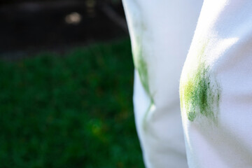 Close up stain of fresh grass on white clothes. outodors. space for text