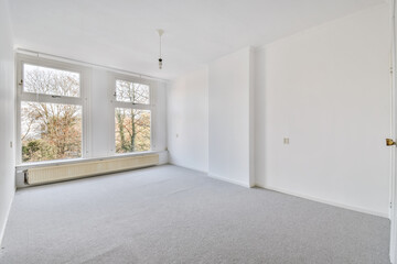 interior of an empty bright room with grey carpeting floor