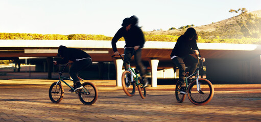 Landing the perfect trick. Full length shot of a young male BMX rider doing tricks around the city.