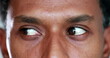 Leinwandbild Motiv Extreme close-up of african american man eyes looking up , down and sideways