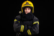 © blanke1973 - Firefighter fully equipped with helmet and ax in smoke, black background