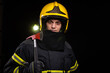 © blanke1973 - Firefighter fully equipped with helmet and ax in smoke, black background