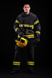 © blanke1973 - Firefighter fully equipped with helmet and ax in smoke, black background