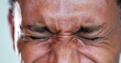 © Marco - African man eyes squinting. Close-up black guy closing eyes squint