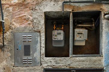 Poster - Detail of electricity and gas meters on the exterior wall of an old house, Italy