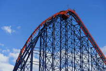 A Large Red Steel Rollercoaster In Blackpool Beach, England