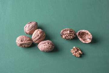 Sticker - A top view of walnuts isolated on green background