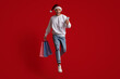 © Prostock-studio - Online Offer. Man In Santa Hat Jumping With Smartphone And Shopping Bags