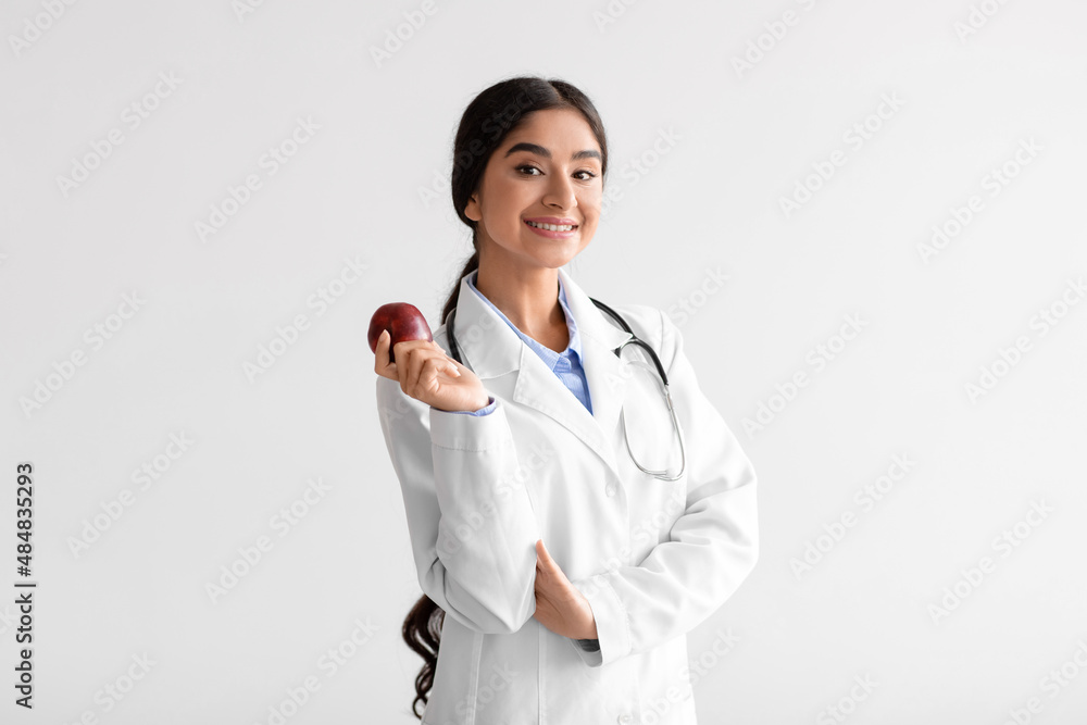 Happy pretty young indian woman doctor dentist in white coat with ...
