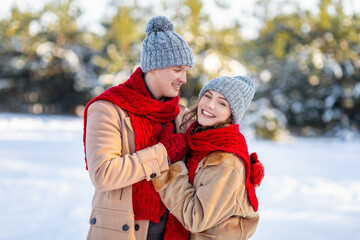 Loving man and woman enjoying weekend at winter forest