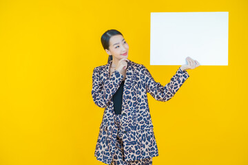 Wall Mural - Portrait beautiful young asian woman with empty white billboard